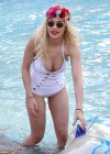 Rita Ora Flaunt her bikini body in white swimsuit in a swimming pool in Dubai